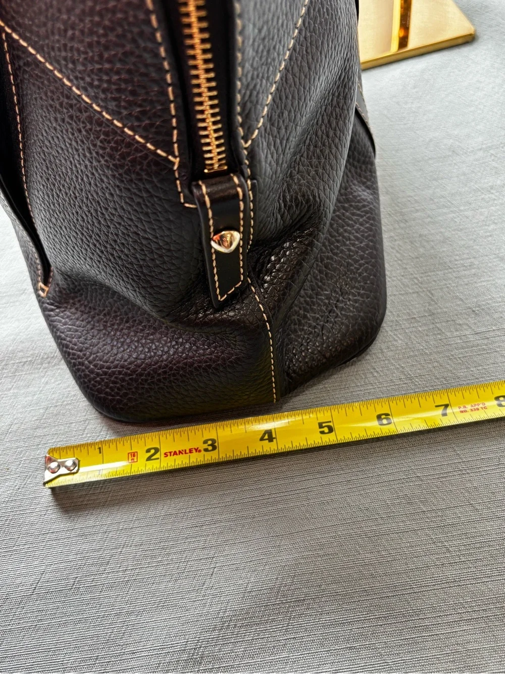 Dooney & Bourke Black Leather Satchel with Gold Hardware and Tassel